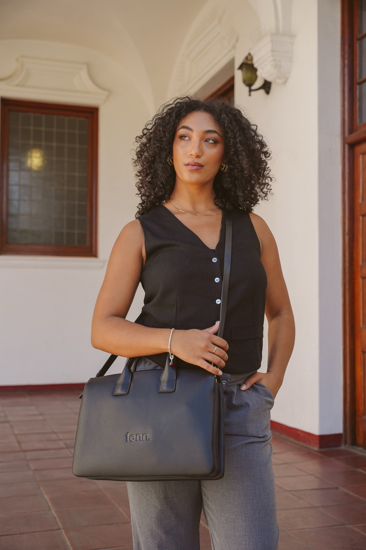 Woman carrying a black FENN laptop bag
